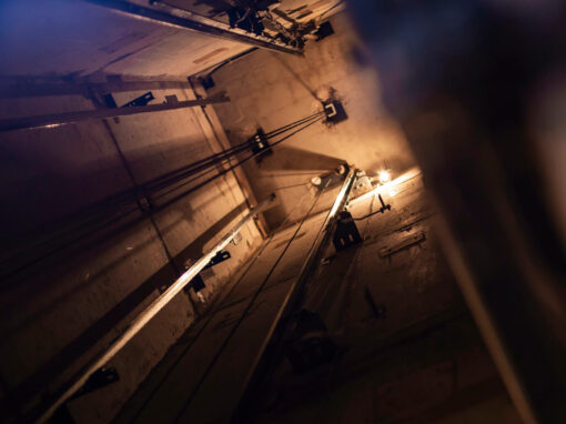 View looking up at the top of an elevator shaft.